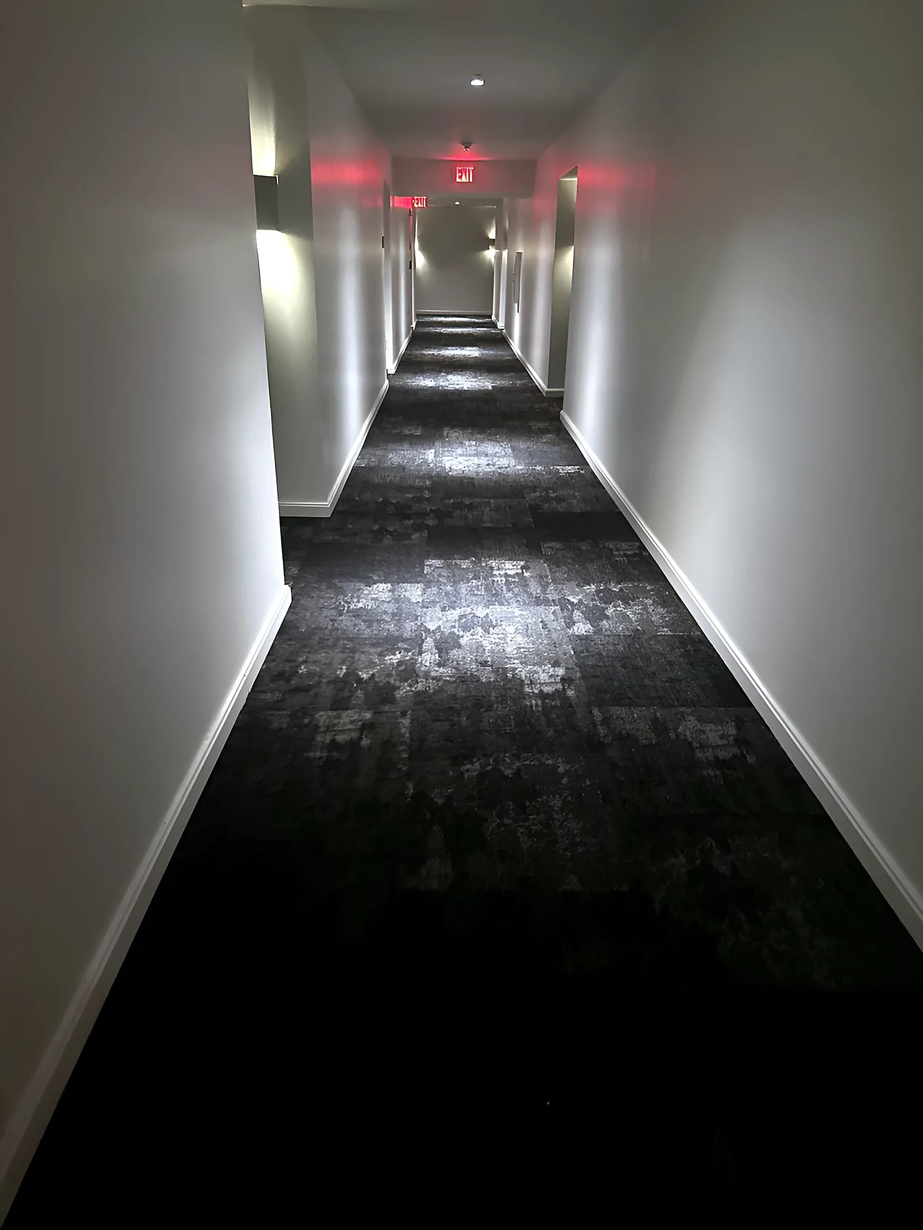 Long corridor view with the carpet pattern receding