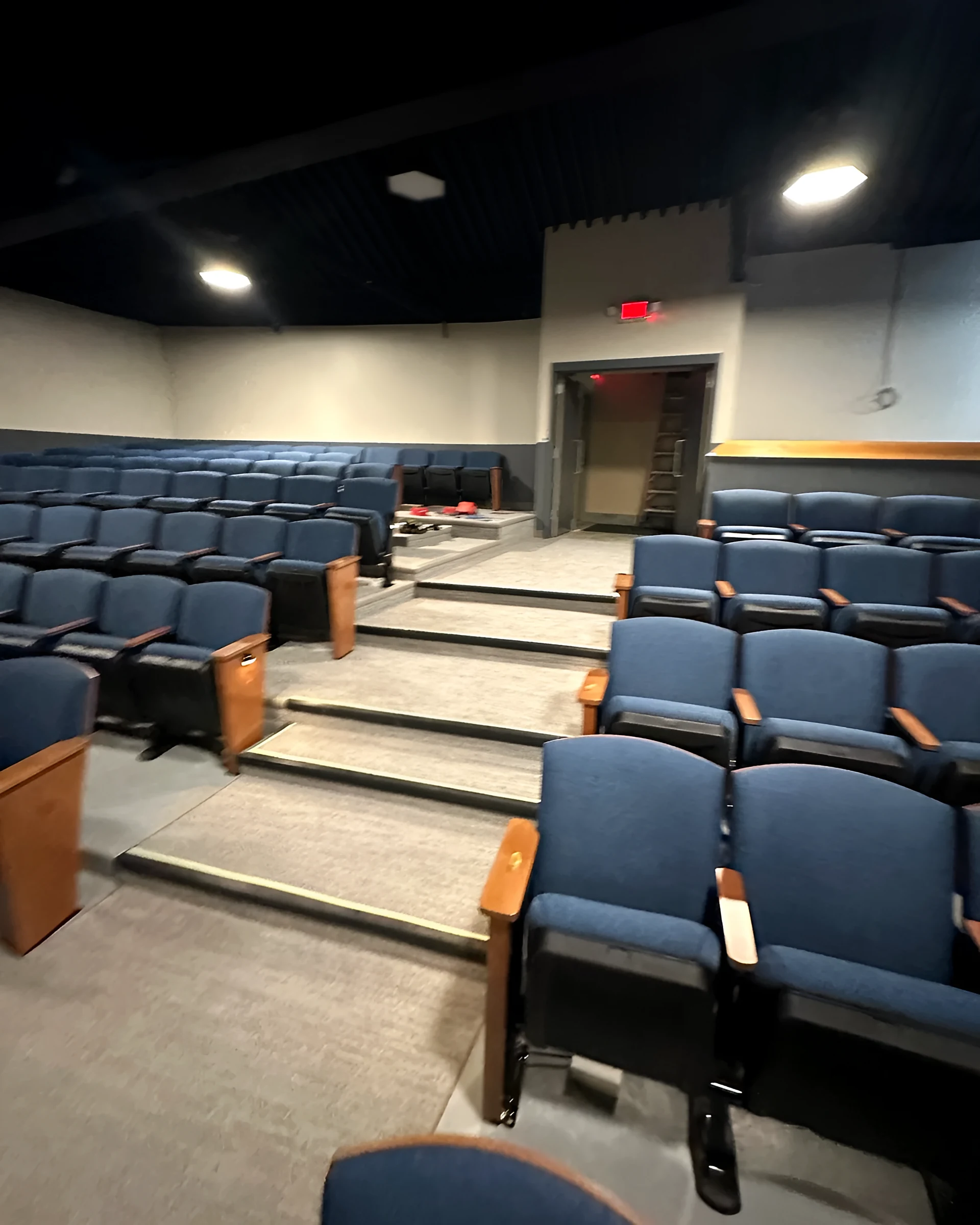 Stairs with photoluminescent nosings between seating sections
