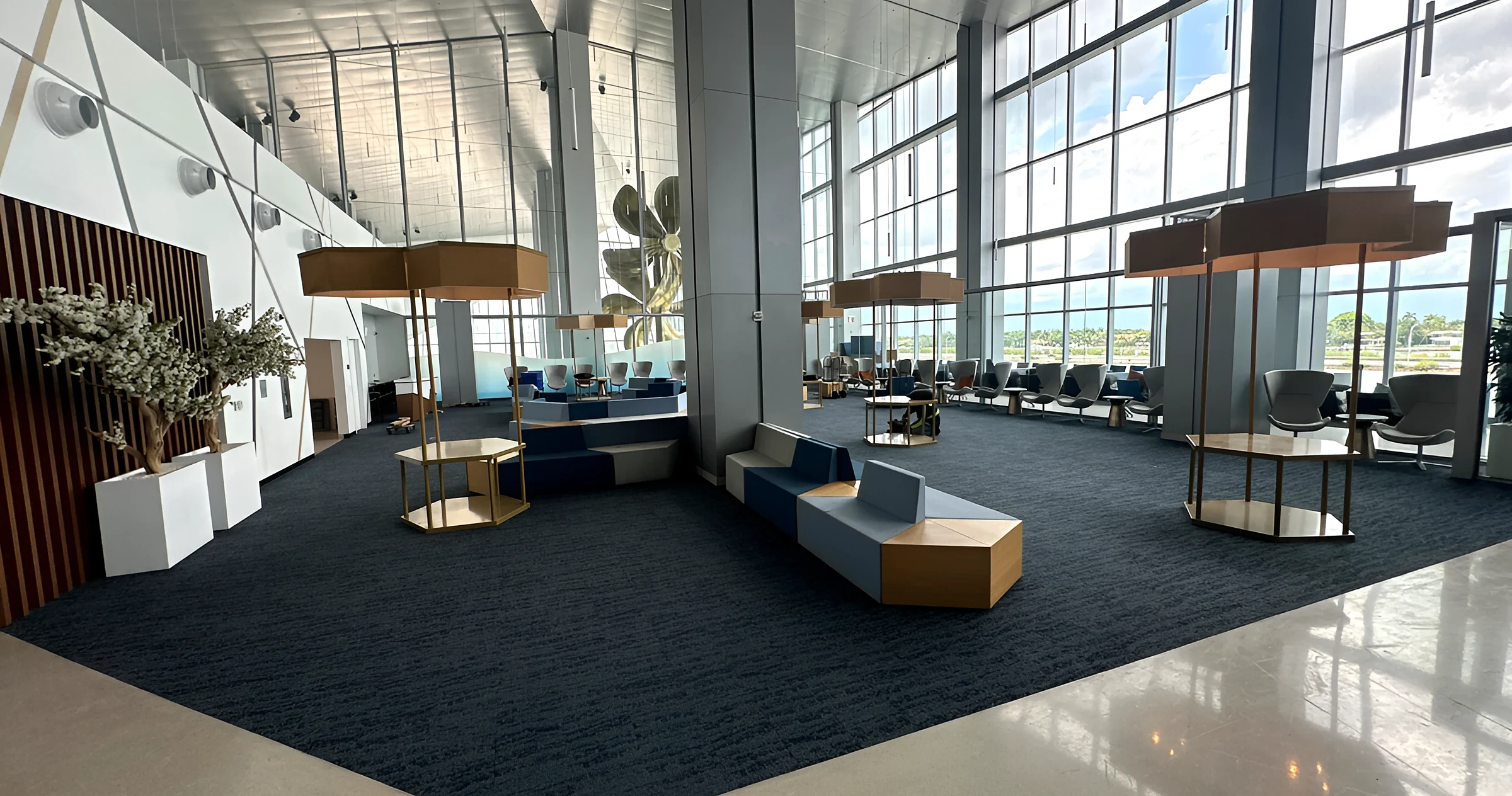 The Royal Caribbean terminal suite lounge with dark carpet plank beneath a glass wall