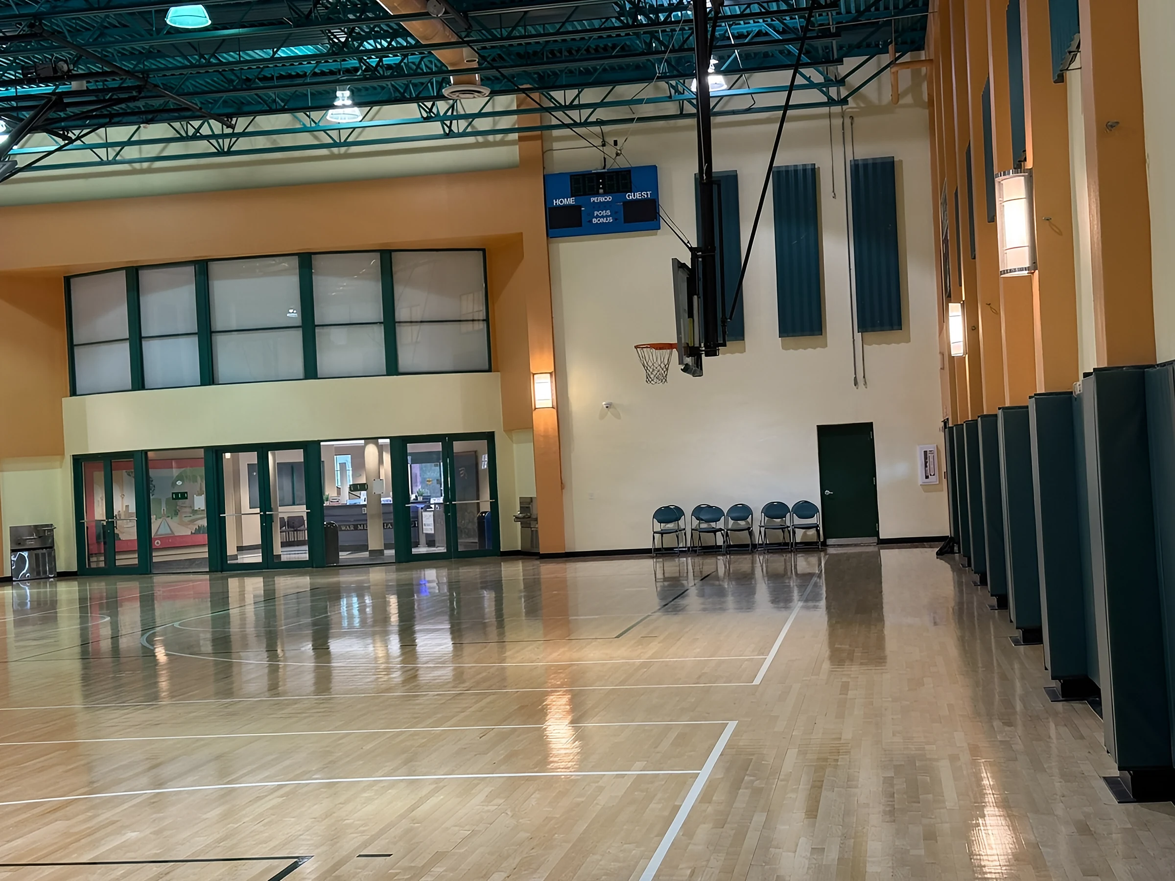 New wall pads and fresh paint along the end wall of the gym