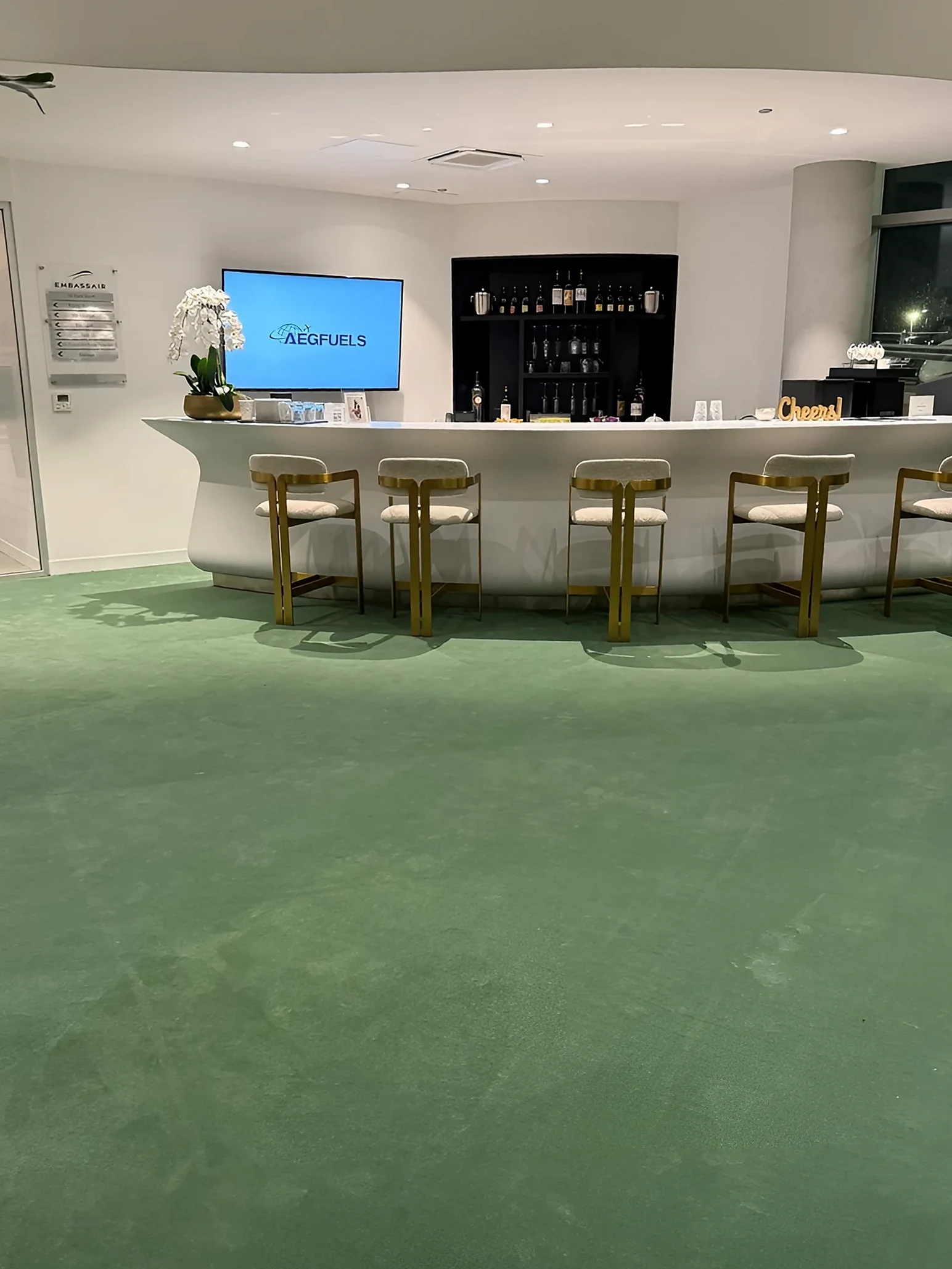 The terminal bar and gold stools on the new green broadloom