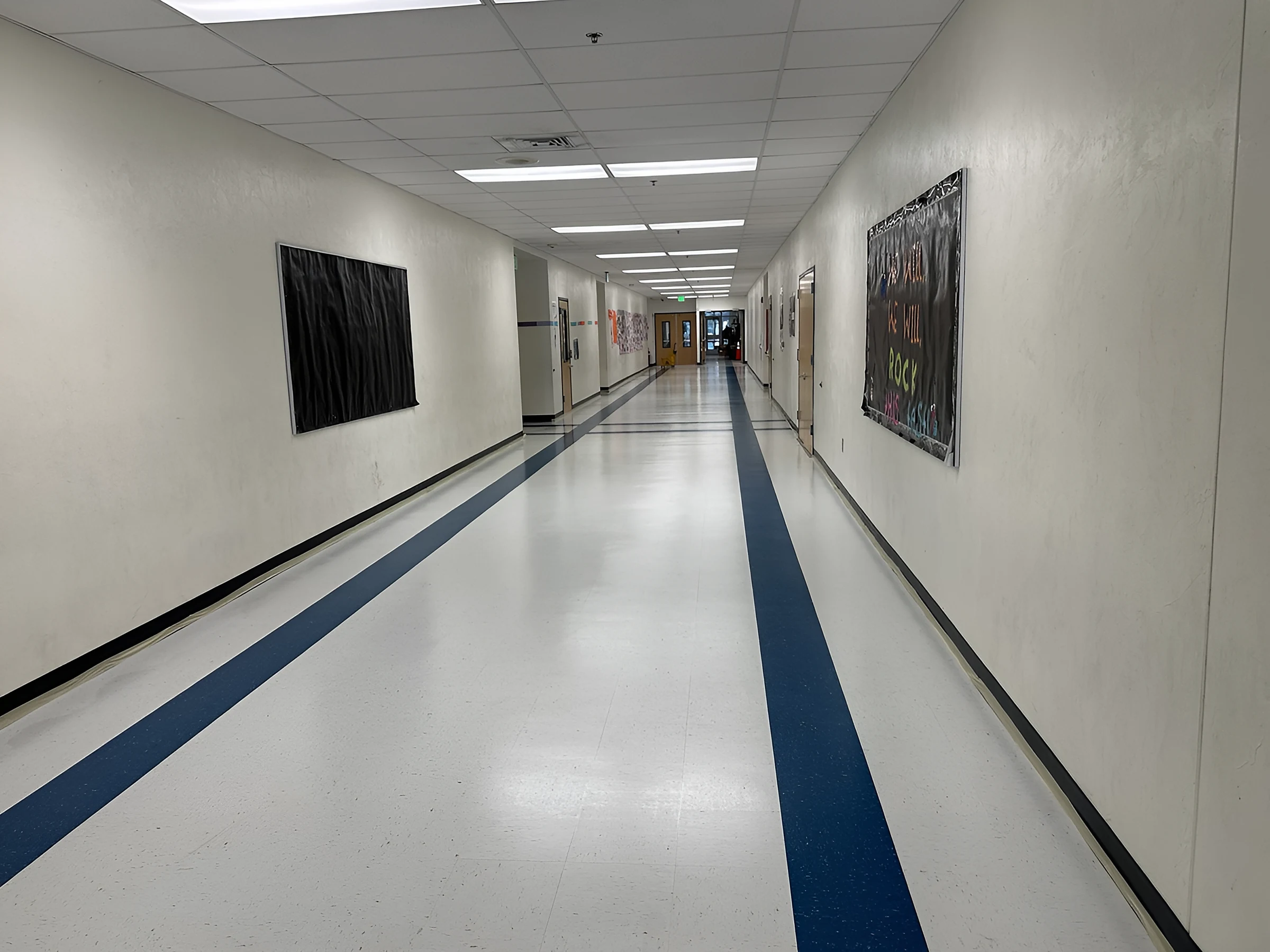 White tile corridor with long blue bands