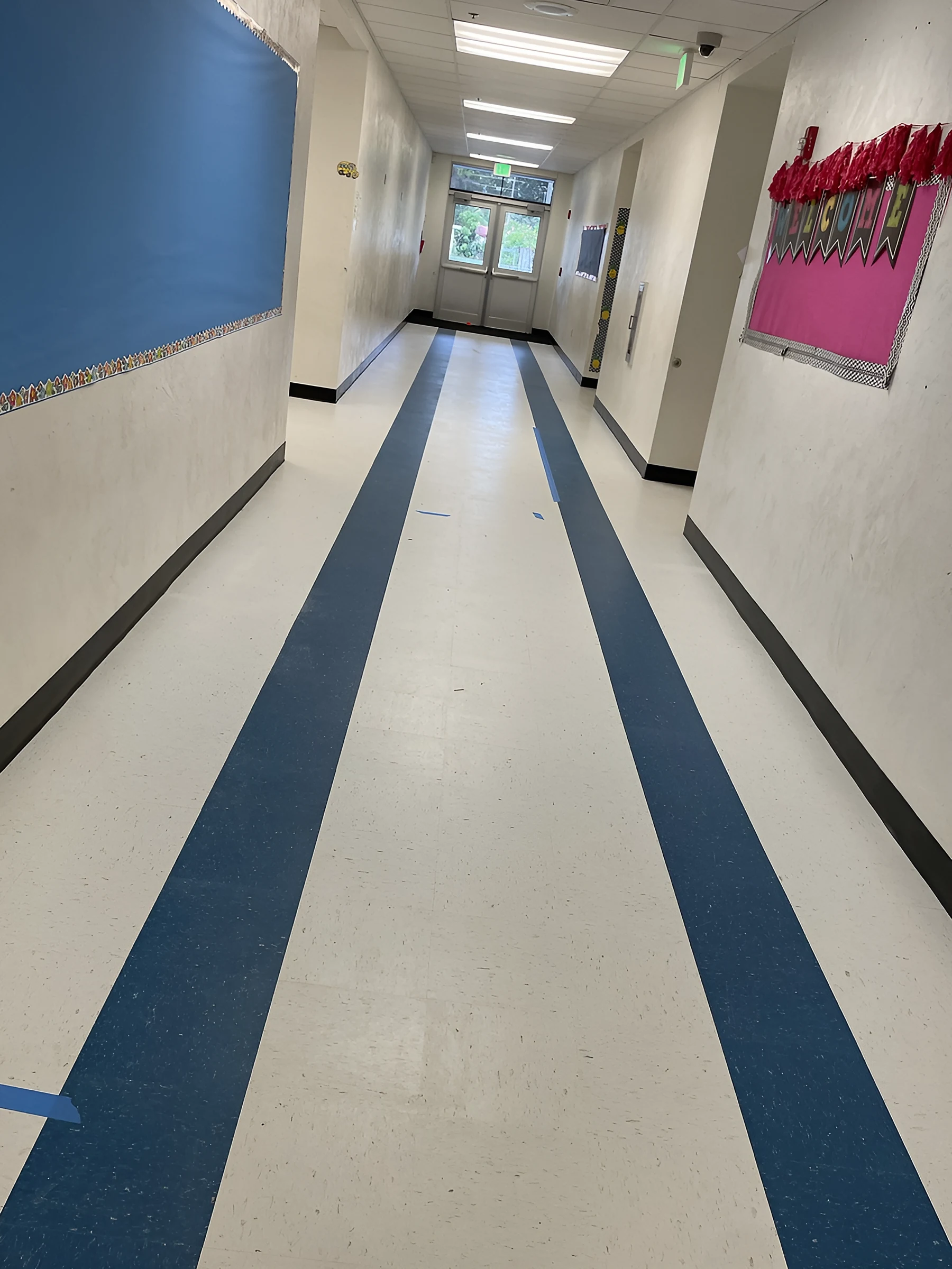 Two blue bands running down a hallway