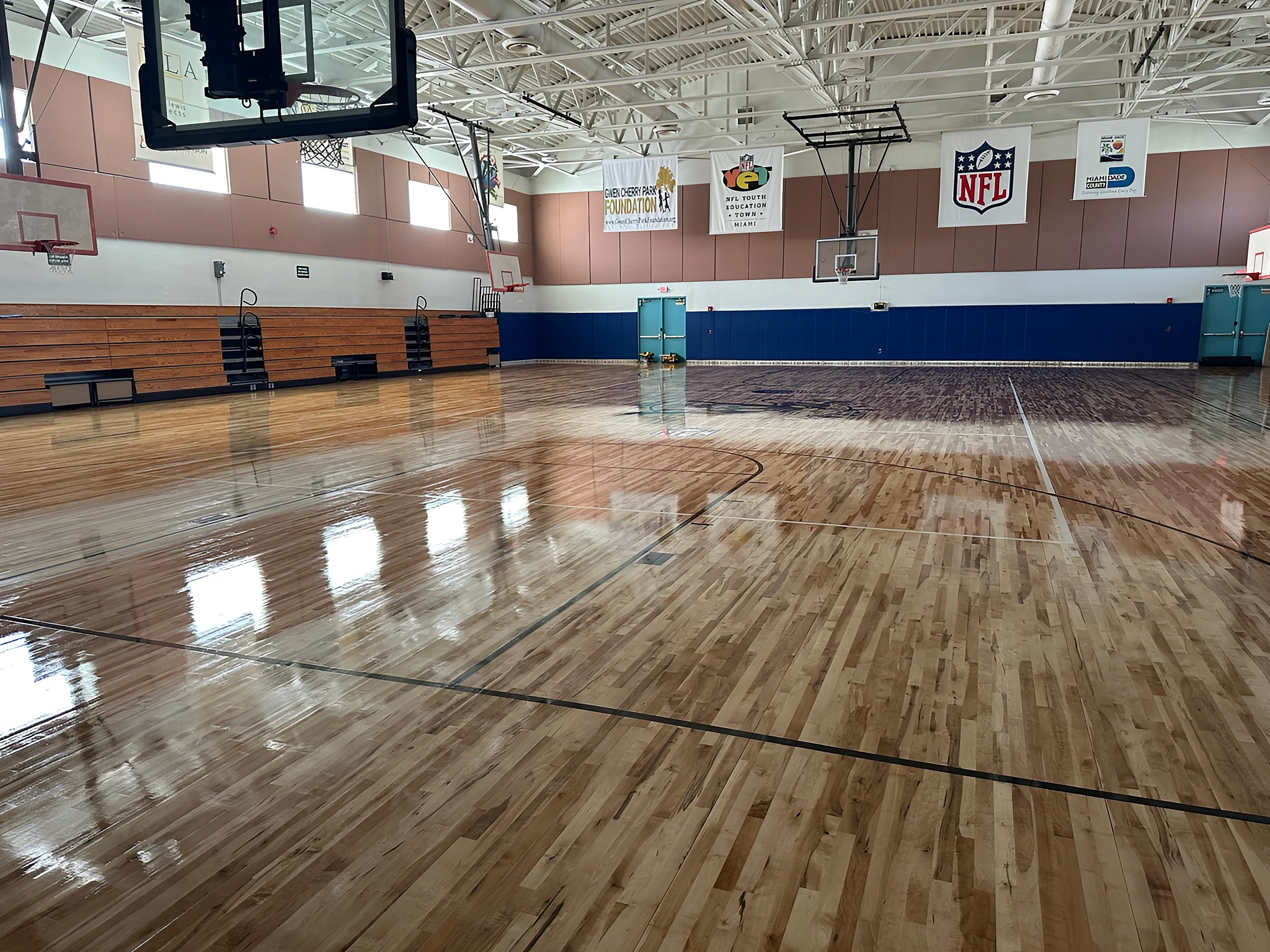 The full court reflecting the gym lights after sealing