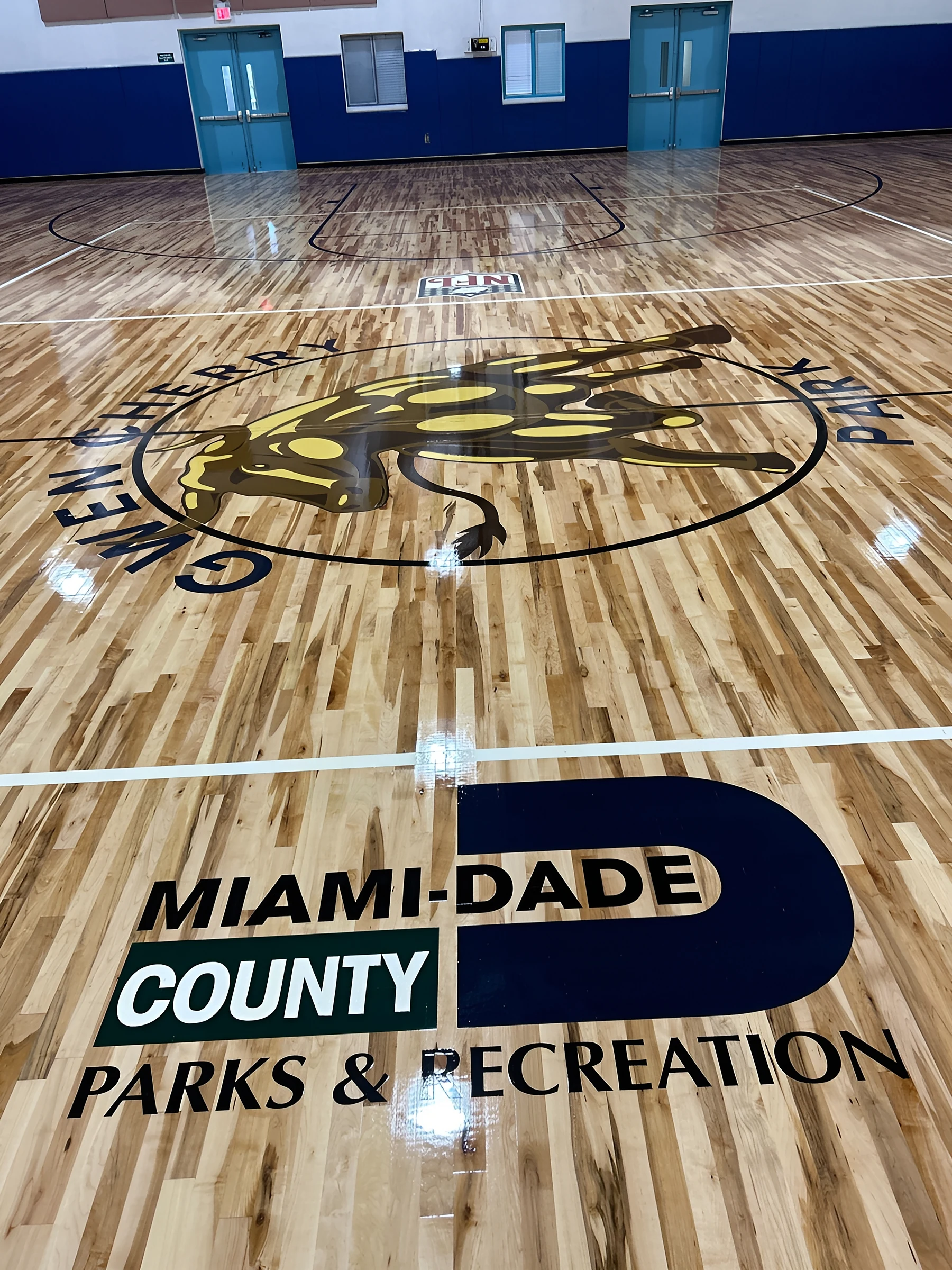 Gwen Cherry Park seal at center court above the Miami-Dade County Parks & Recreation logo