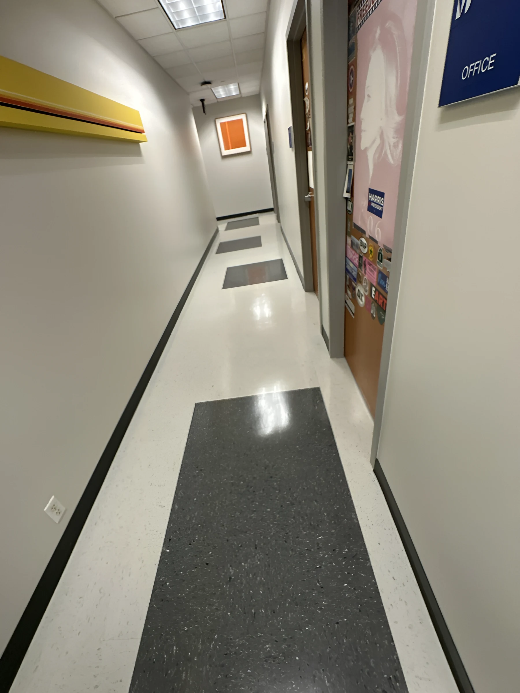 The department corridor with charcoal squares at each door
