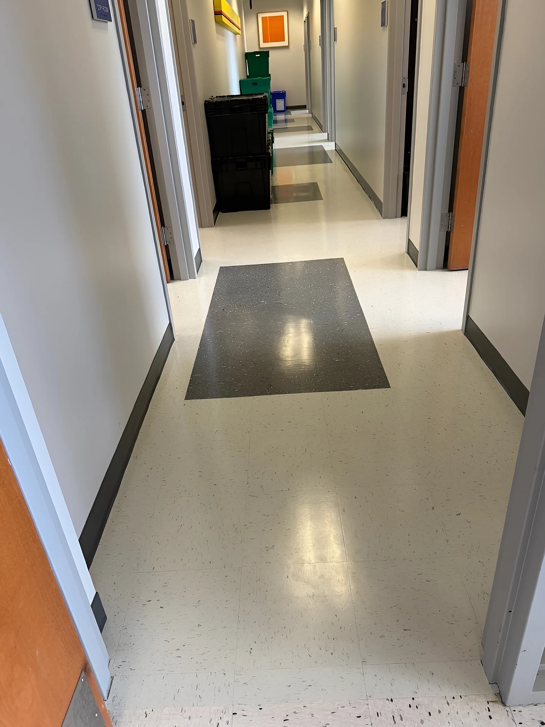 A charcoal square marking an office entry
