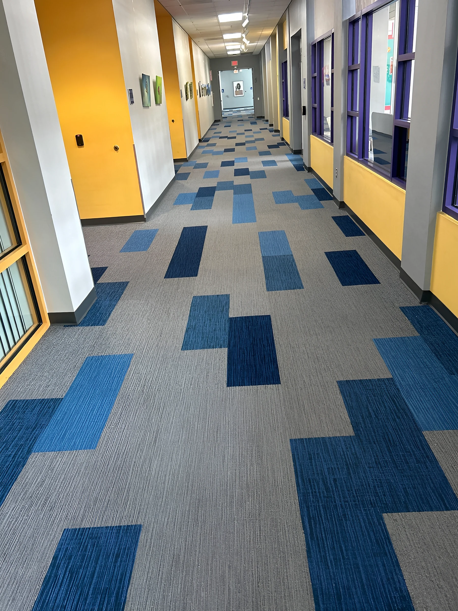 Long blue planks scattered across the grey corridor field