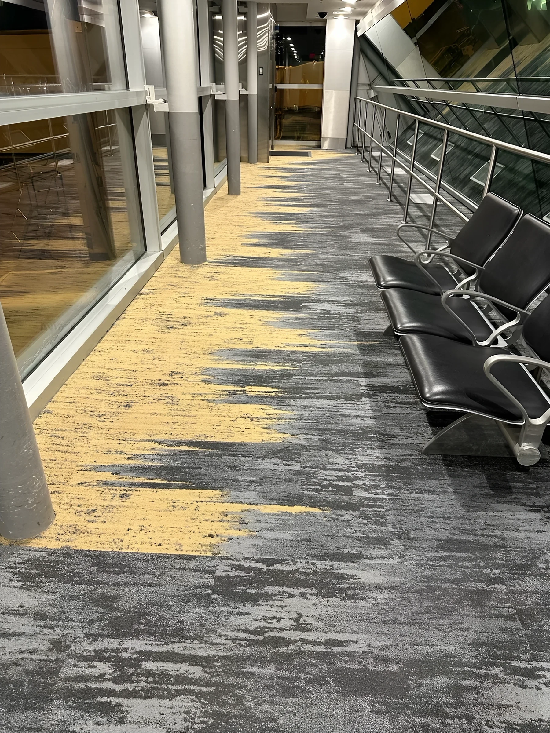 Yellow breaking through the grey field beside the gate seating