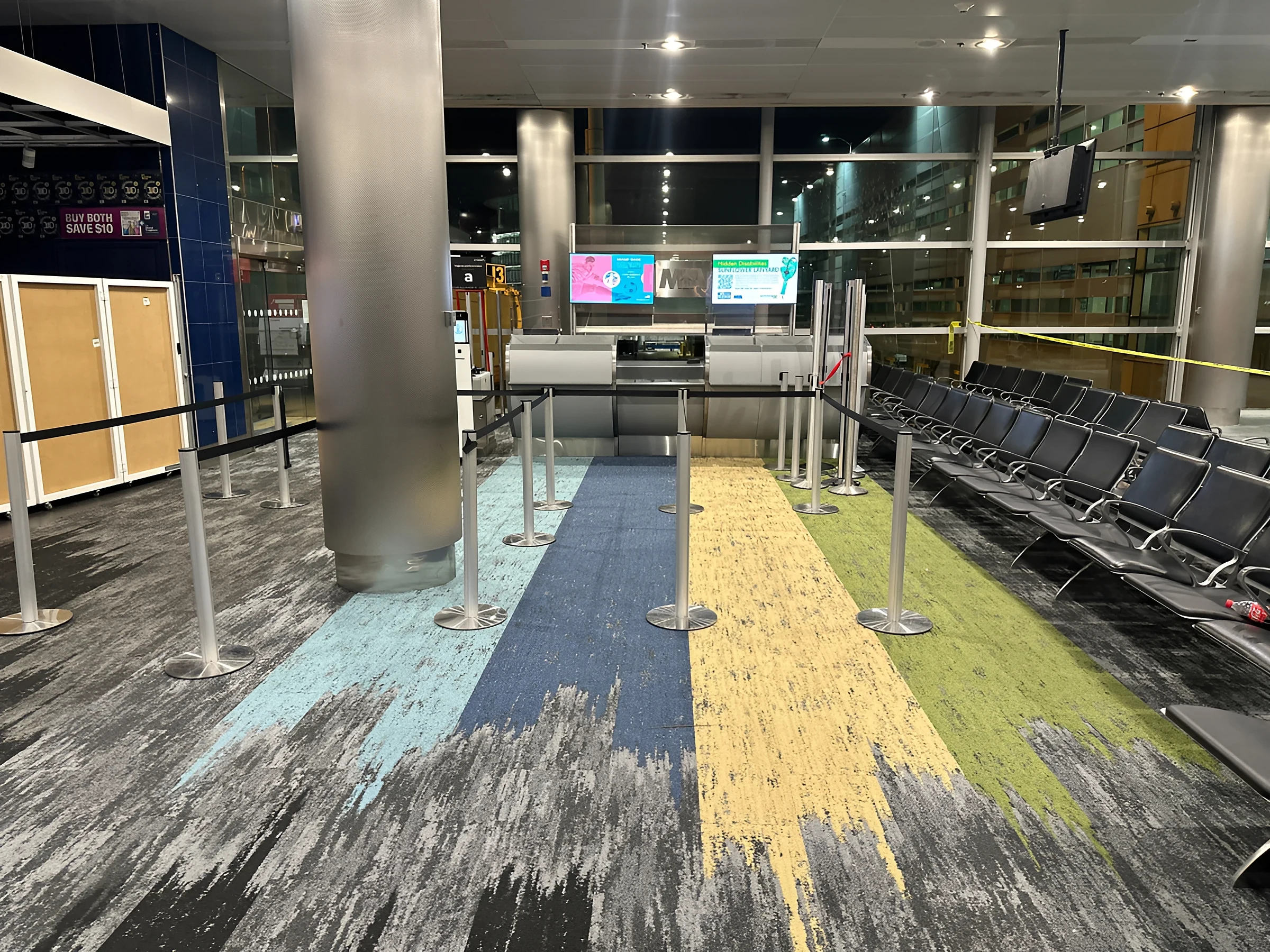 Queue lanes in blue, yellow and green on the new Concourse J carpet
