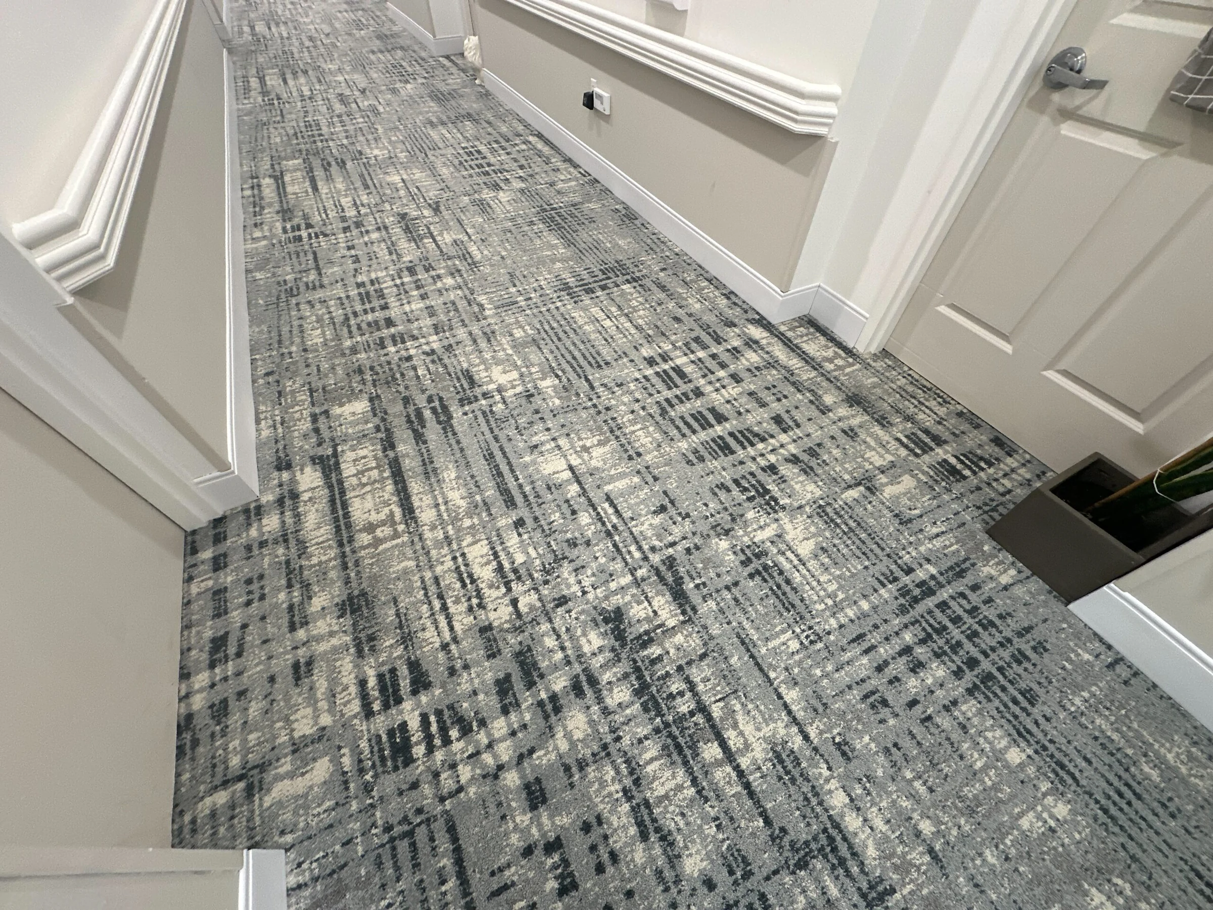 The patterned carpet running past residents’ doors
