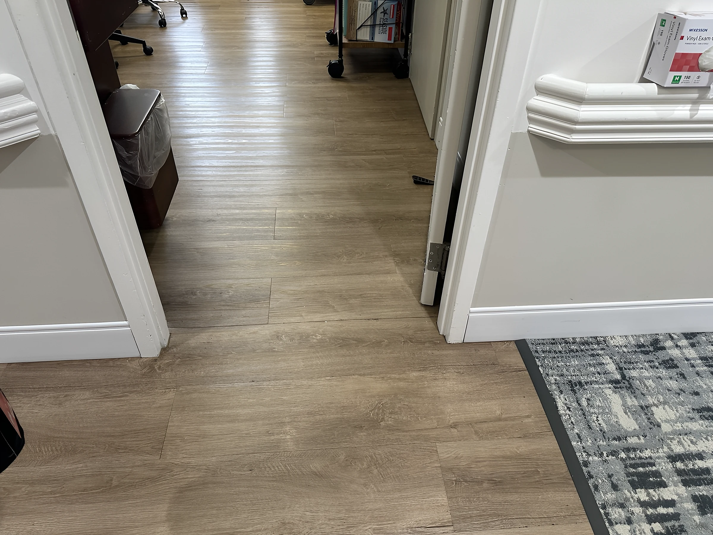 Carpet meeting wood-look plank at a doorway