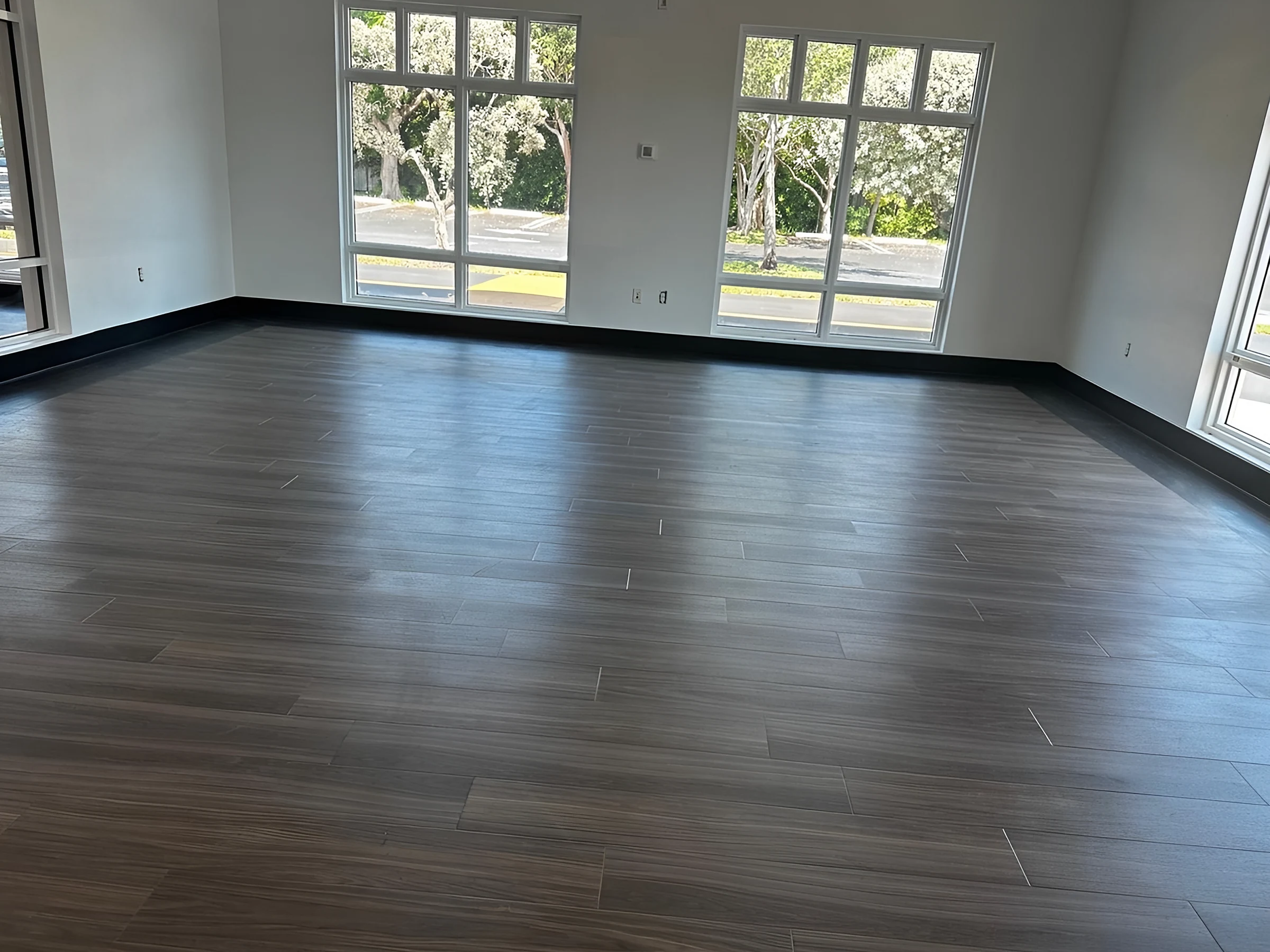 The new wood-look vinyl floor in the Palmer Trinity café, framed by a dark border and black base