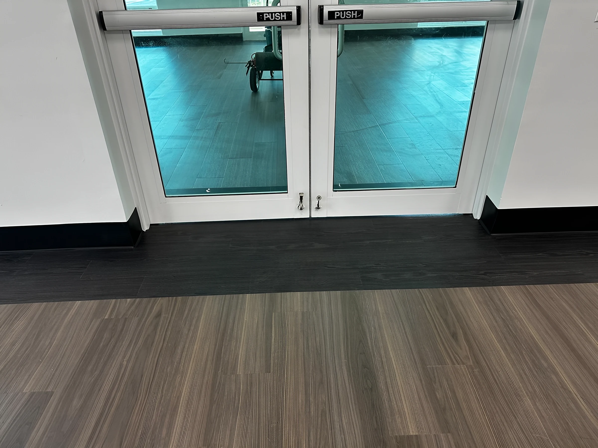 A dark threshold band across the café doors