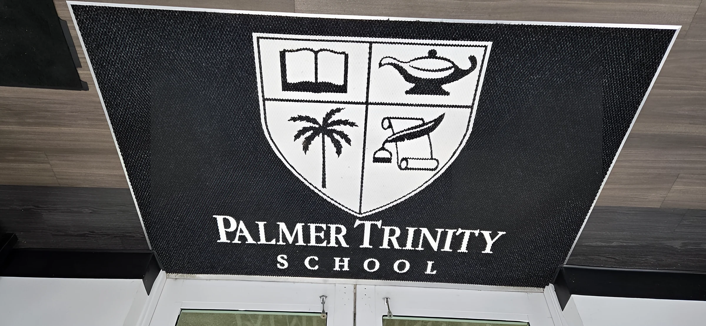 Palmer Trinity School crest inlaid in the entrance mat