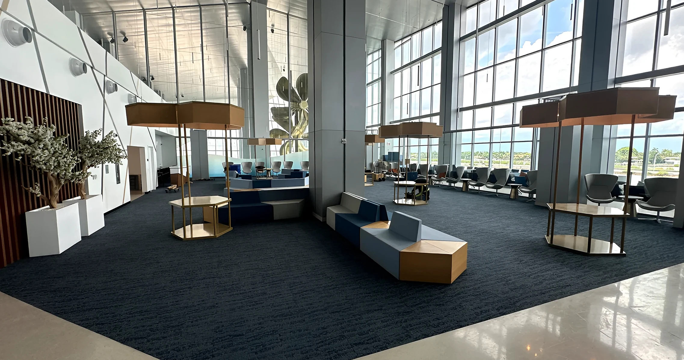 The Royal Caribbean terminal suite lounge with dark carpet plank beneath a glass wall