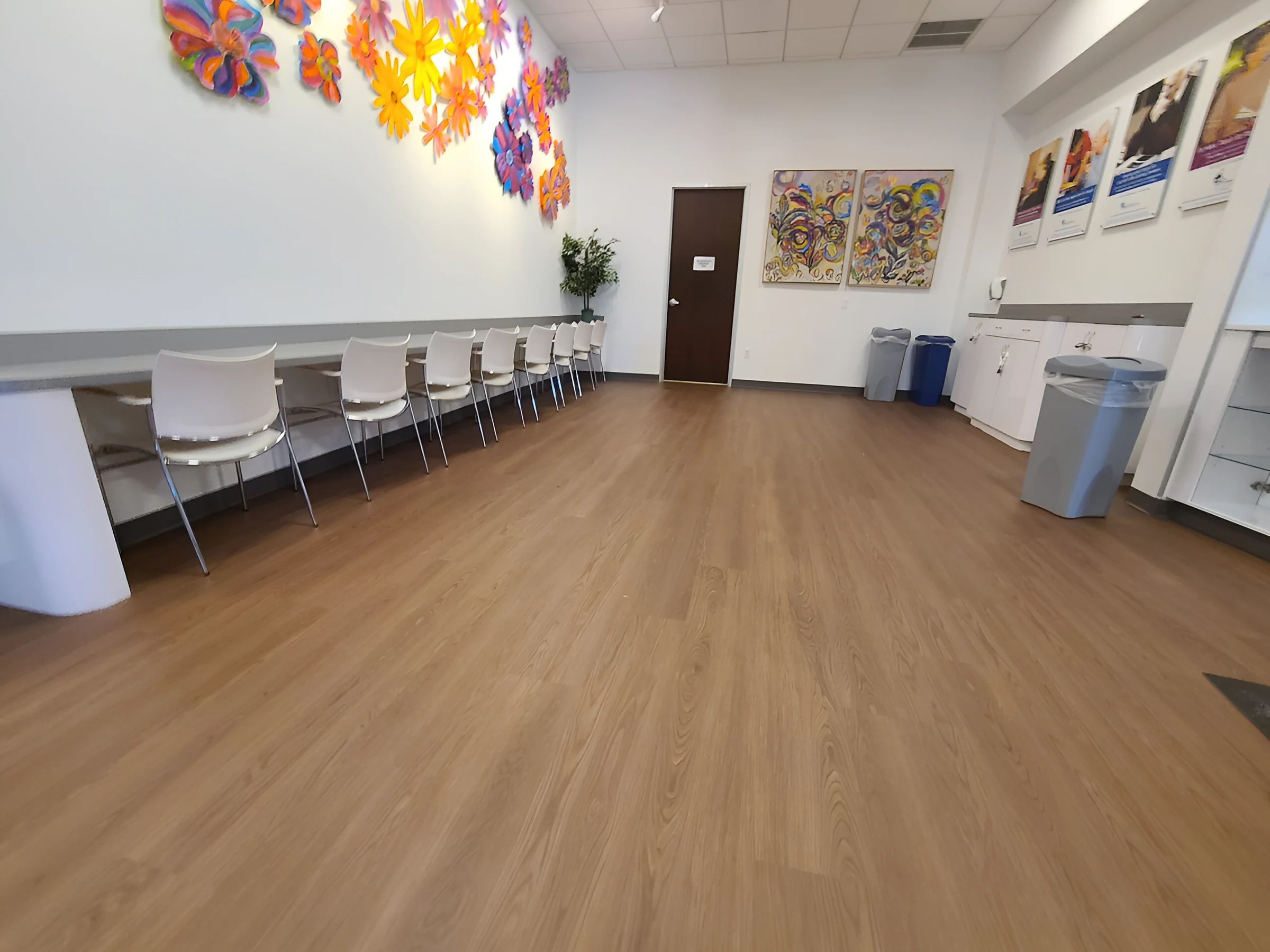 A colorful art wall above the new plank in a gathering room