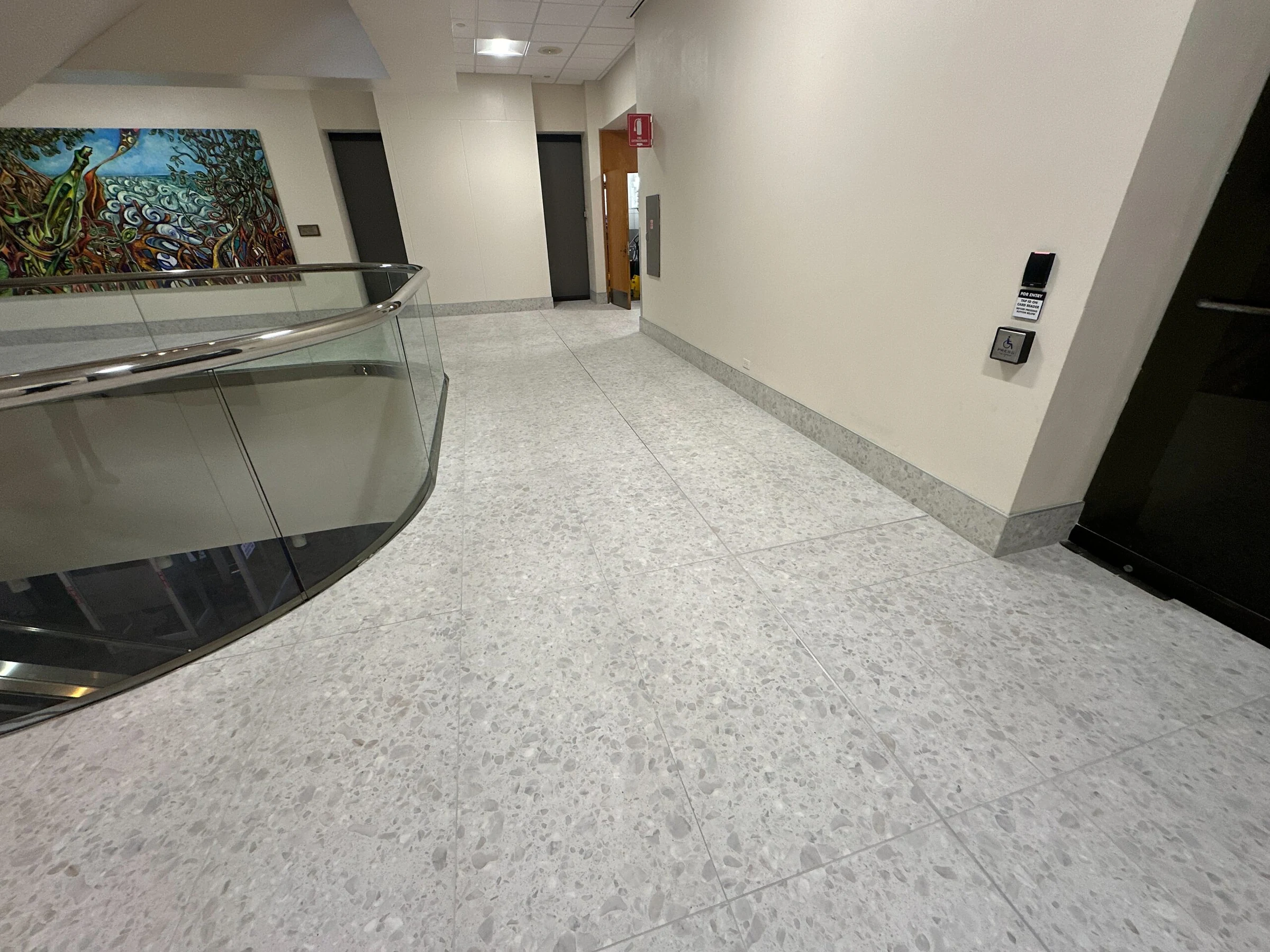 The porcelain floor following a curved glass railing