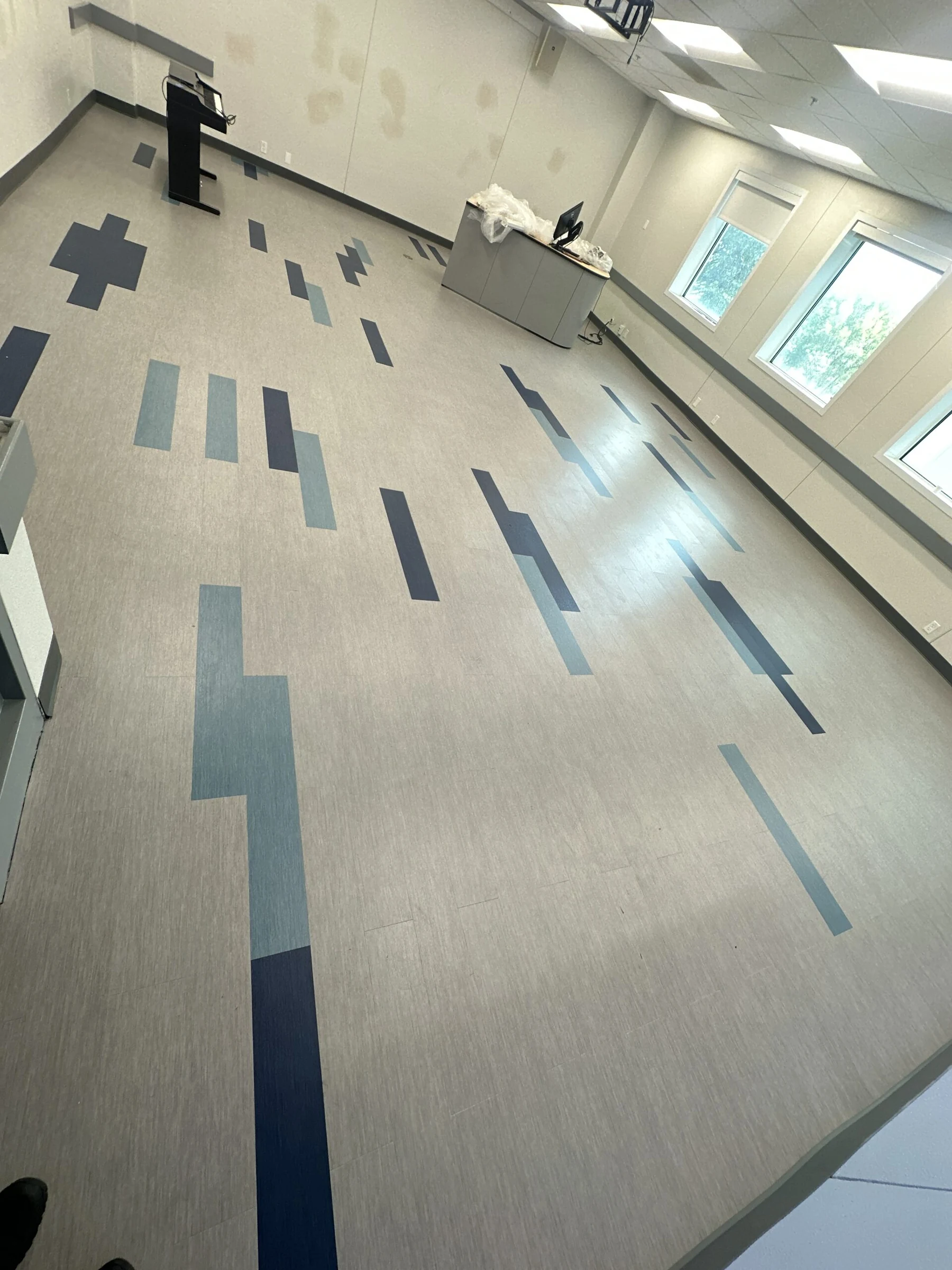 Blue planks scattered across a classroom floor