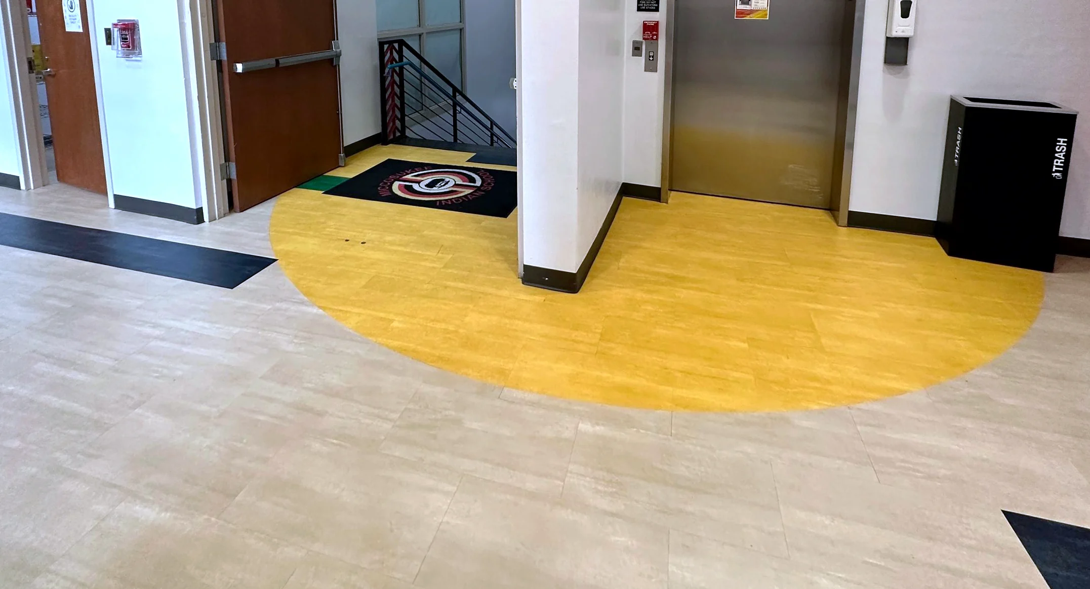A yellow vinyl arc inlaid at the second-floor elevator of the Miccosukee Indian School